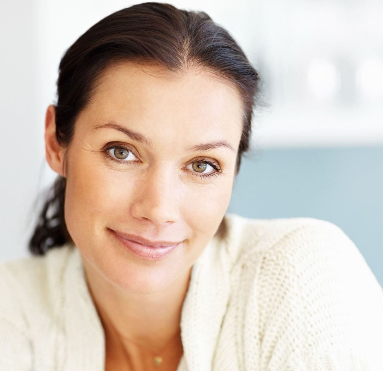 Woman with brown eyes wearing a white sweater
