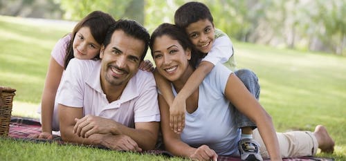 Happy family of four at the park