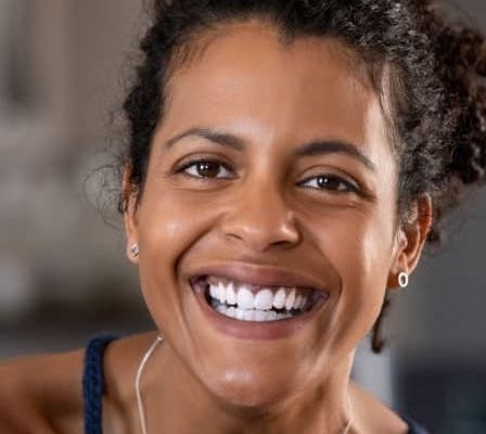 Smiling woman wearing a navy tank top