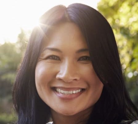 Smiling woman wearing a blue and white patterned dress