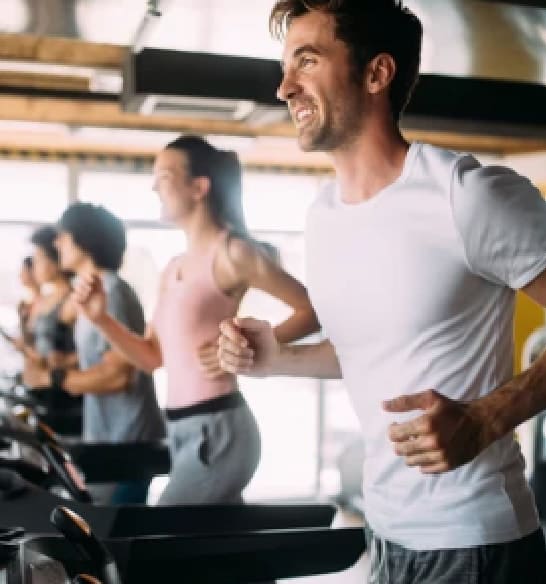 People running on treadmills at the gym