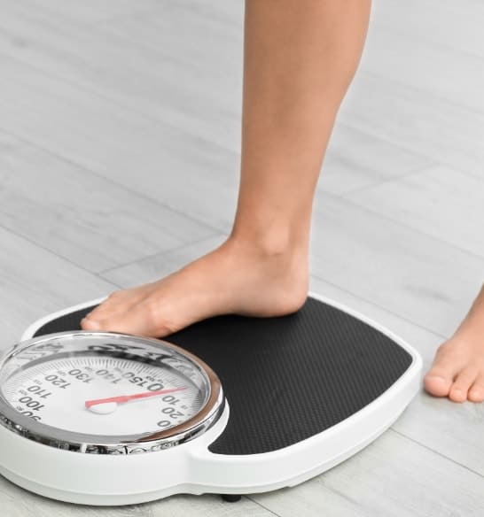 A foot stepping onto a scale