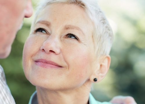 Older woman looking up at her husband, smiling