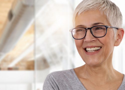 Smiling older woman with short hair wearing glasses