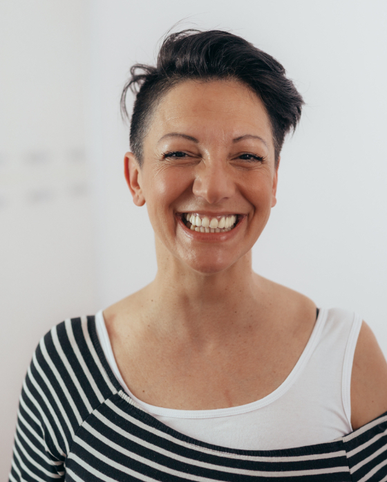 Woman with short hair and a big smile