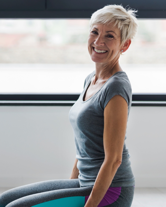 Smiling older woman doing yoga