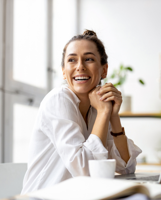 Happy woman sitting in her sitting, laughing